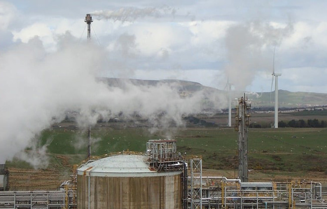 A factory with smoke coming out of it.