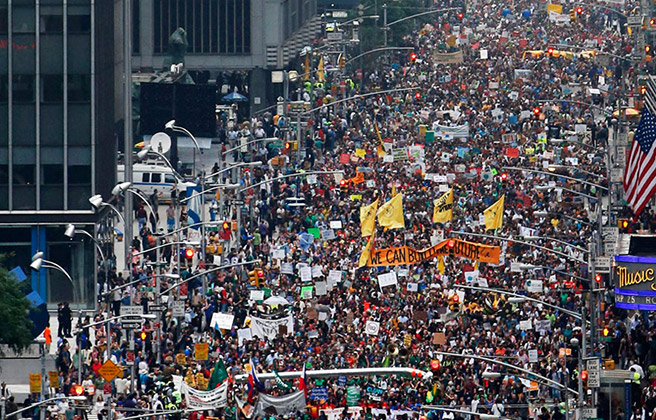 Thousands of people marching in New York City for climate change reform.