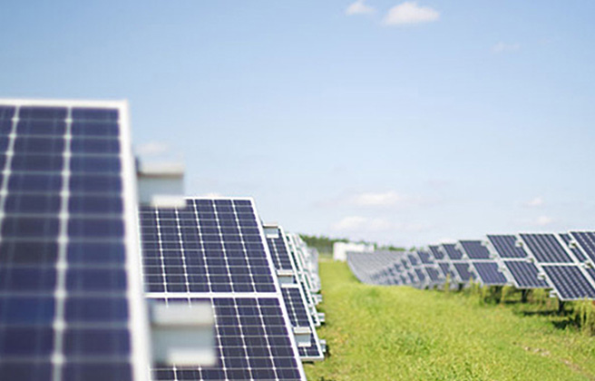 View down a row of solar panels in Europe.