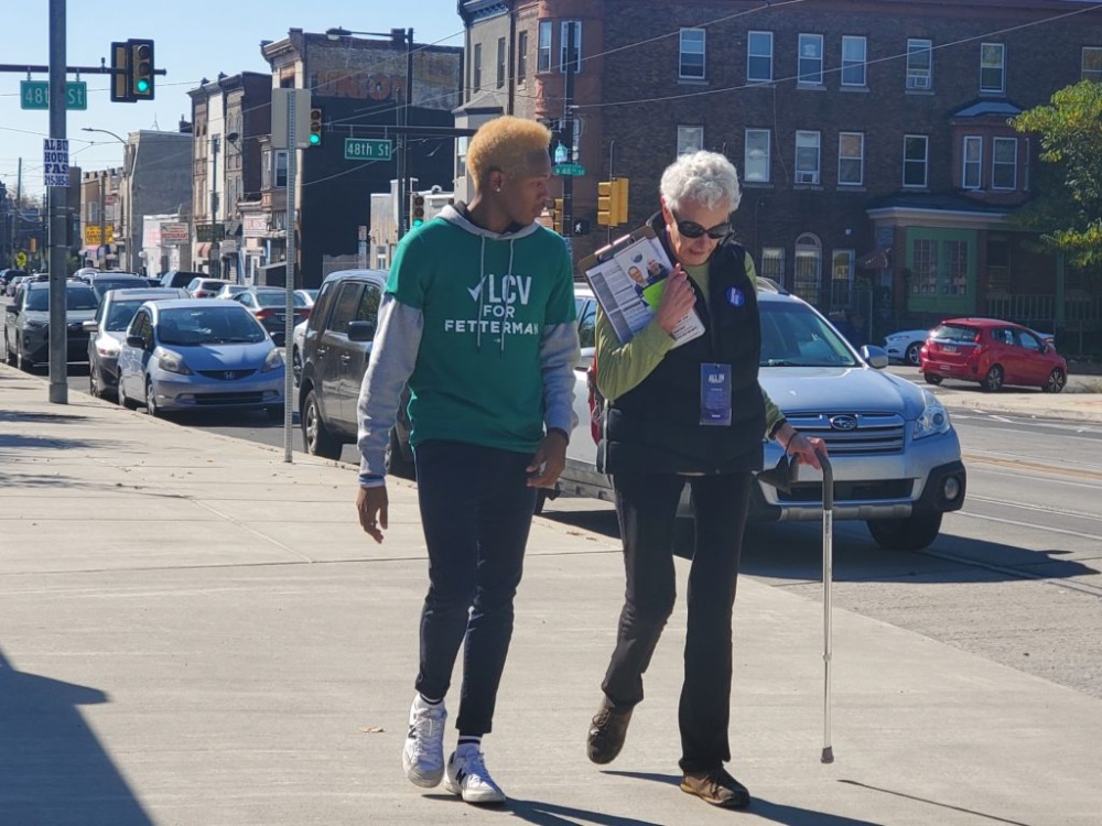 PA volunteer Magali and another volunteer walking down a town street