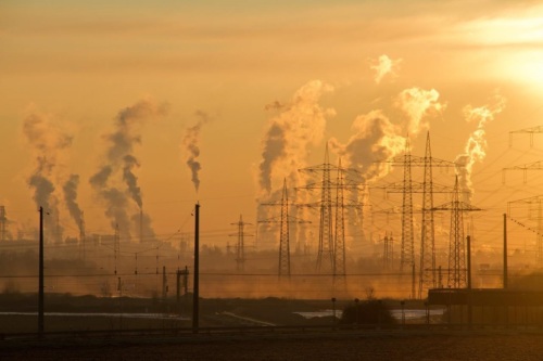 Skyline showing industrial smokestacks at dusk