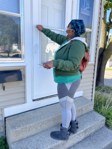 LCV Victory Fund volunteer knocks on a community member's door with a clipboard