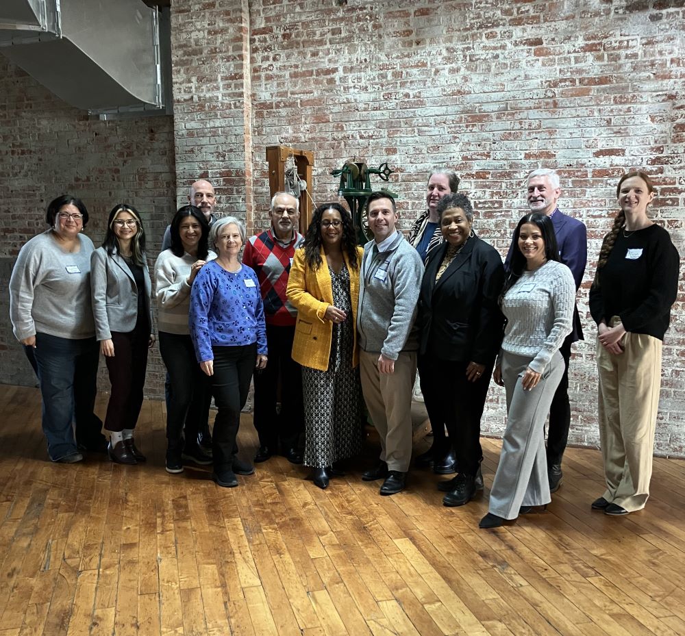 A group photo of 13 men and women who attended the training.