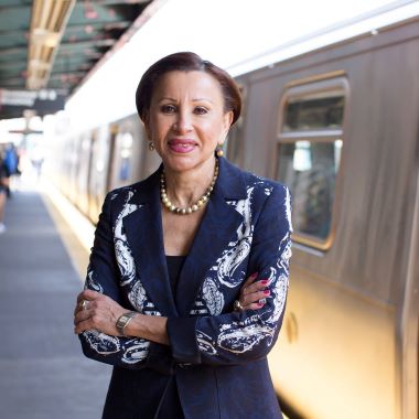 Portrait of Representative Nydia Velazquez standing in front of a Metro car.