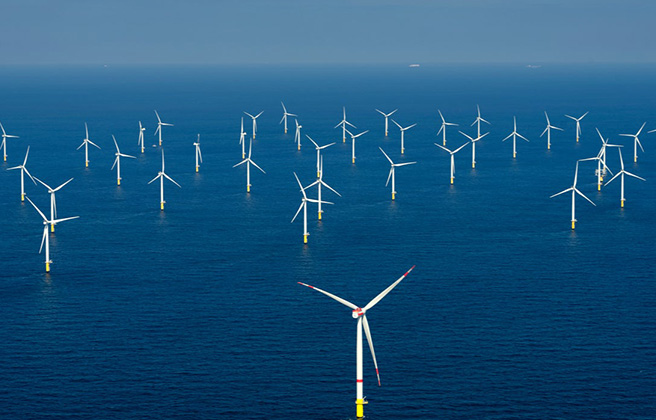 A group of wind turbines in the ocean.