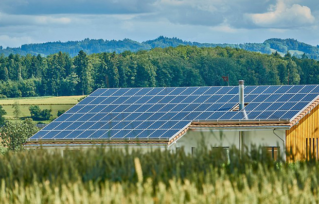 Rooftop solar in front of a mountain range.