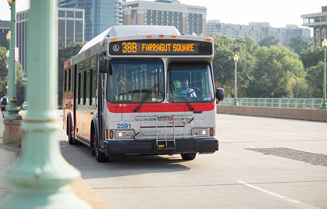 A bus drives on a city street.